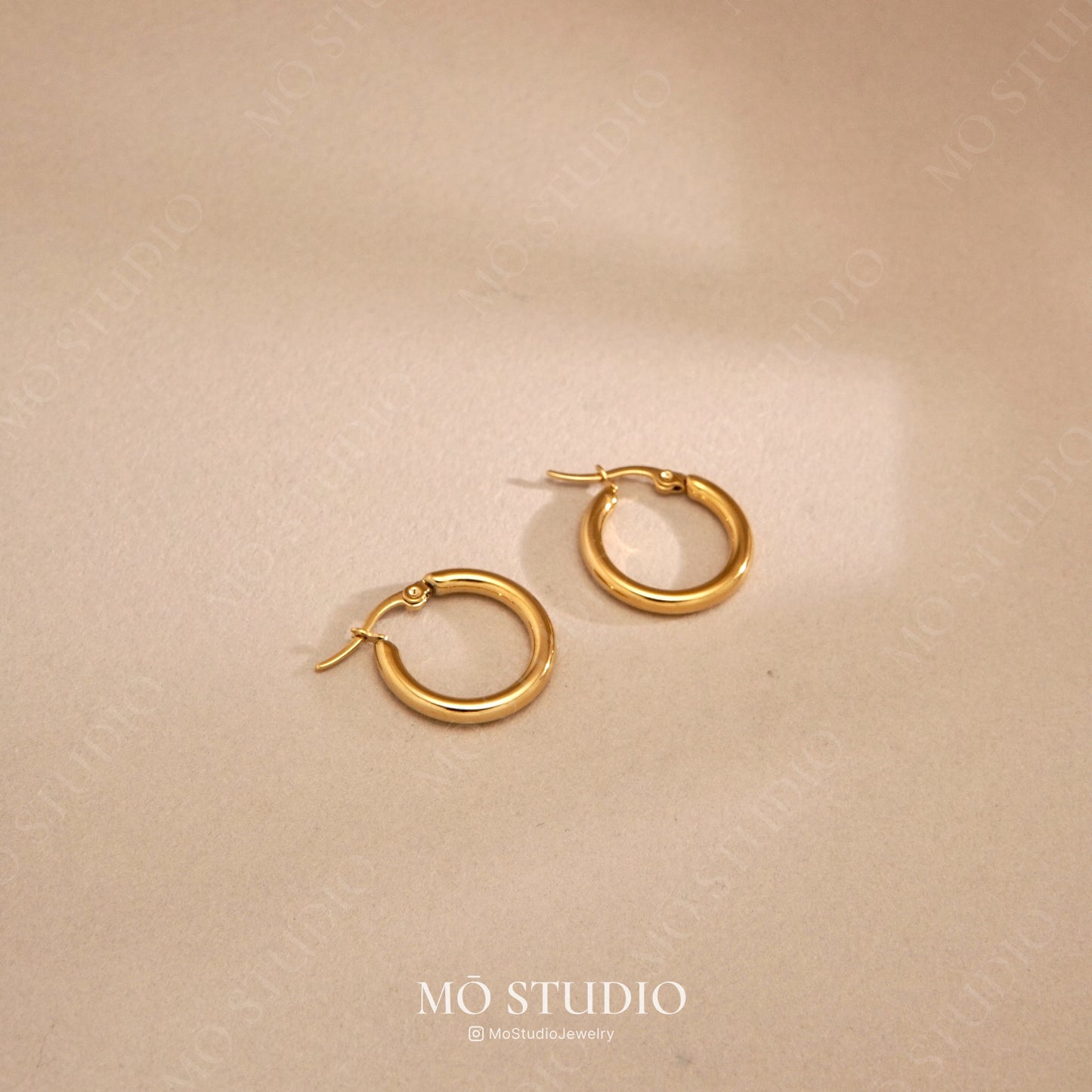 small gold hugger hoops with 18k pvd plating