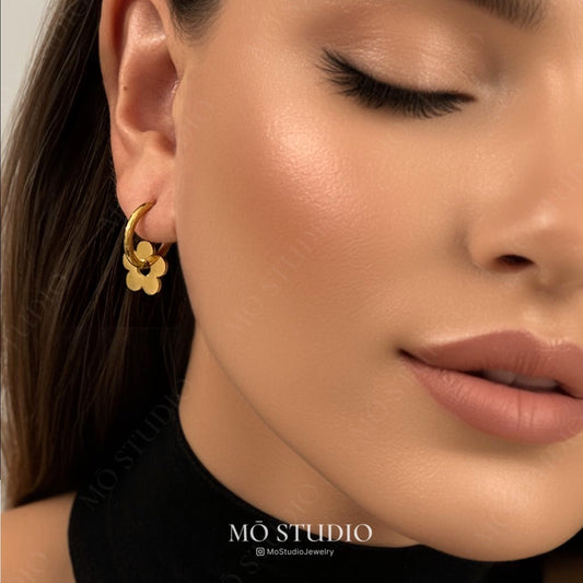 model wearing small gold daisy hoop earrings