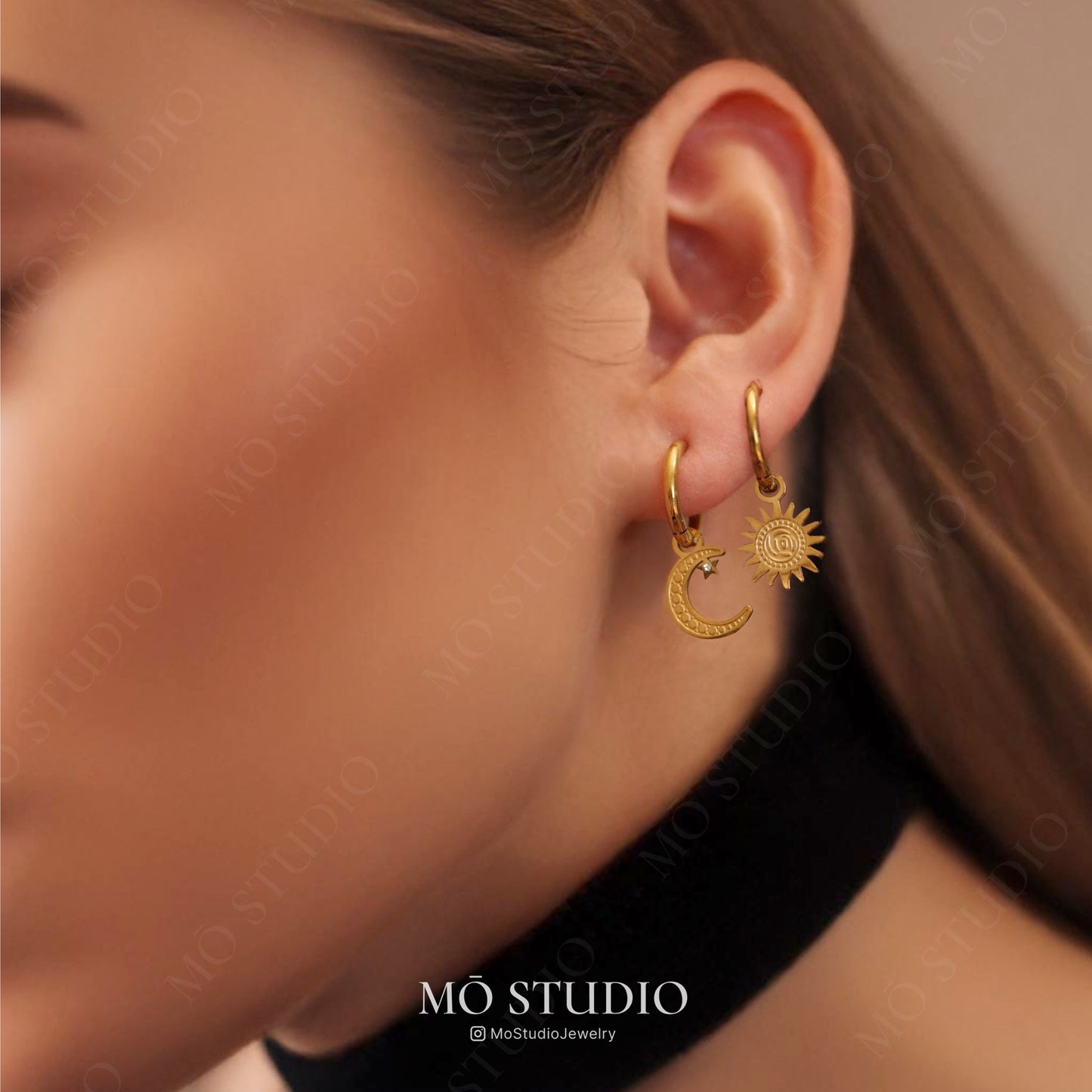 dainty gold hoop earrings with moon and sun charms