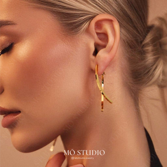 curved geometric dangle earrings in gold