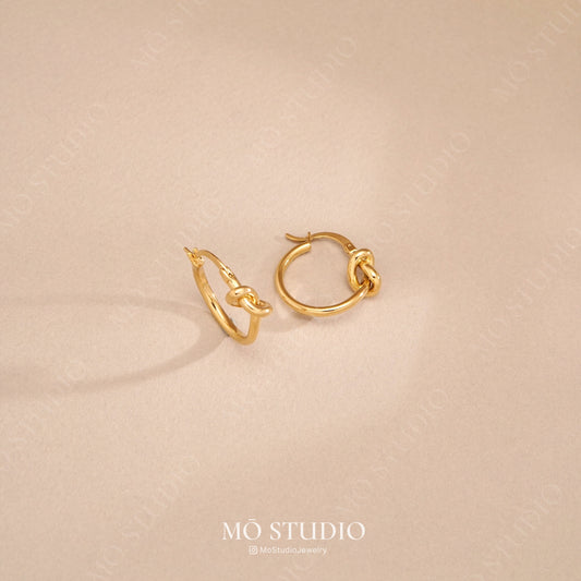 gold knot hoop earrings with twisted loop design