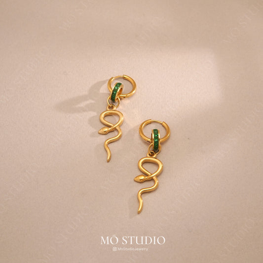 large gold snake hoop earrings with green crystal