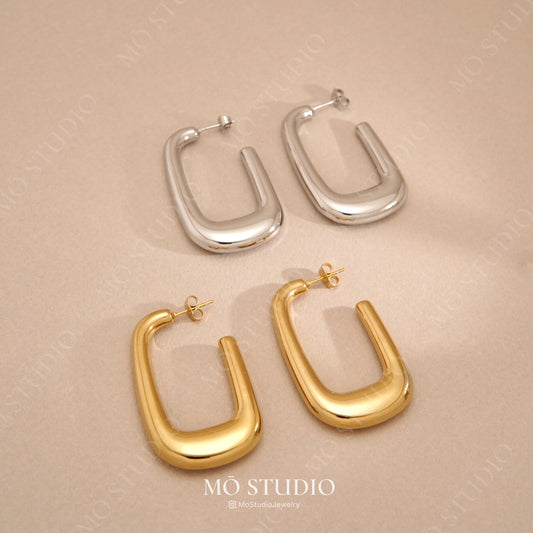 large u-shaped gold and silver hoop earrings statement style